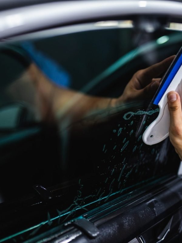 car-tinting-worker-applying-tinting-foil-car-window-1-scaled.jpg